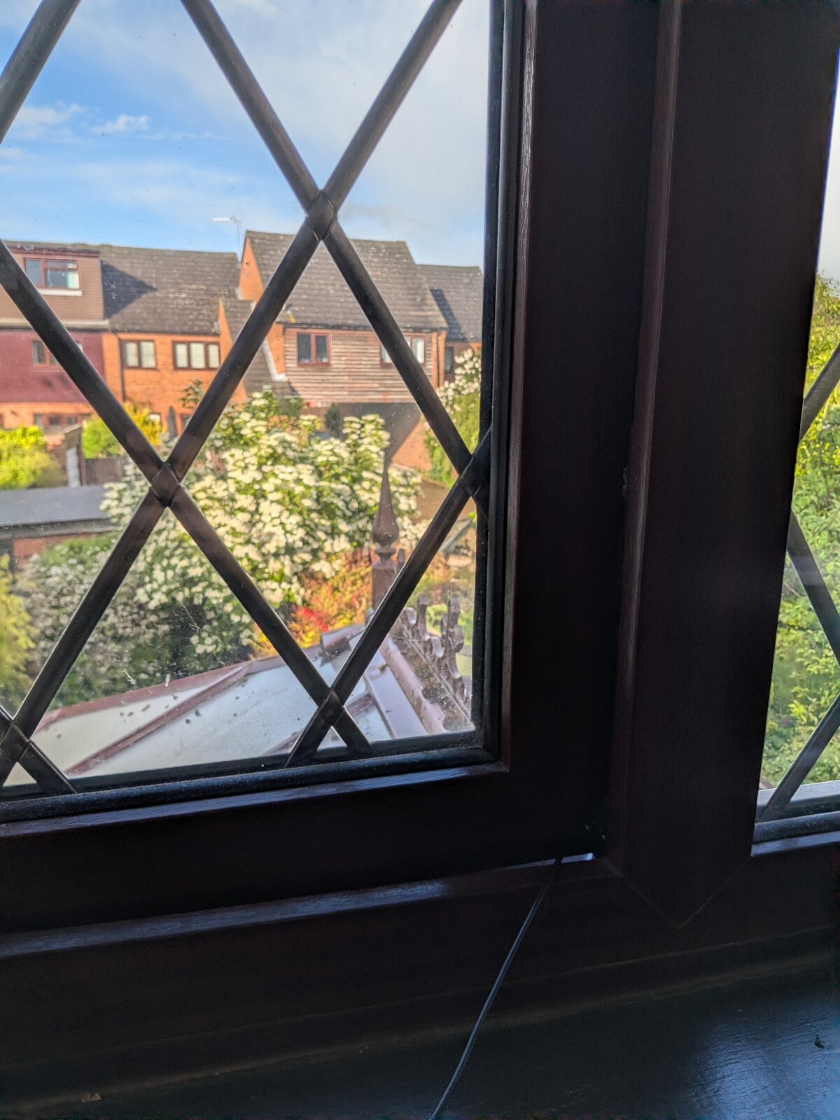 A small USB microphone poking out of a window